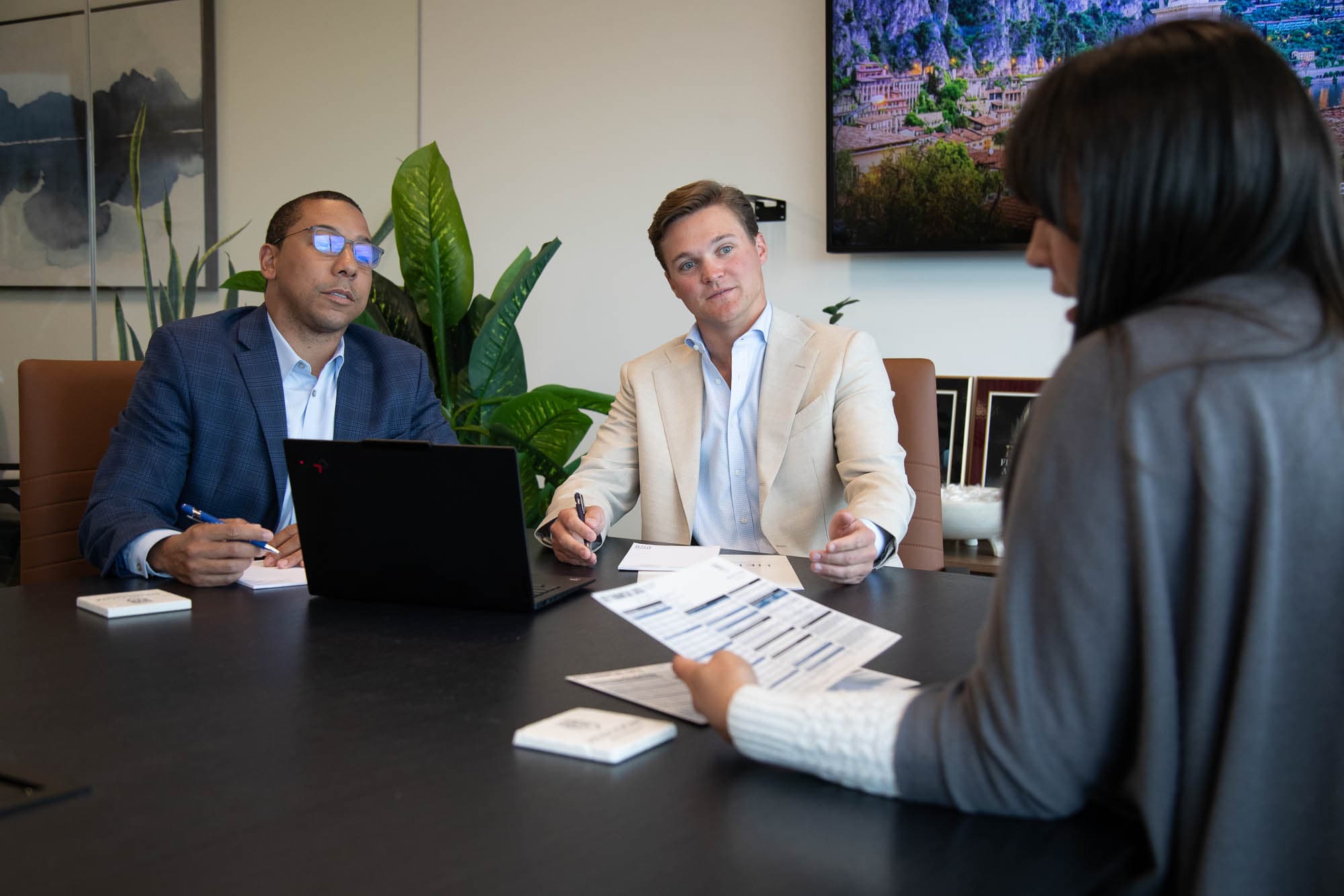 Advisor reviewing insurance coverage documents with a client couple